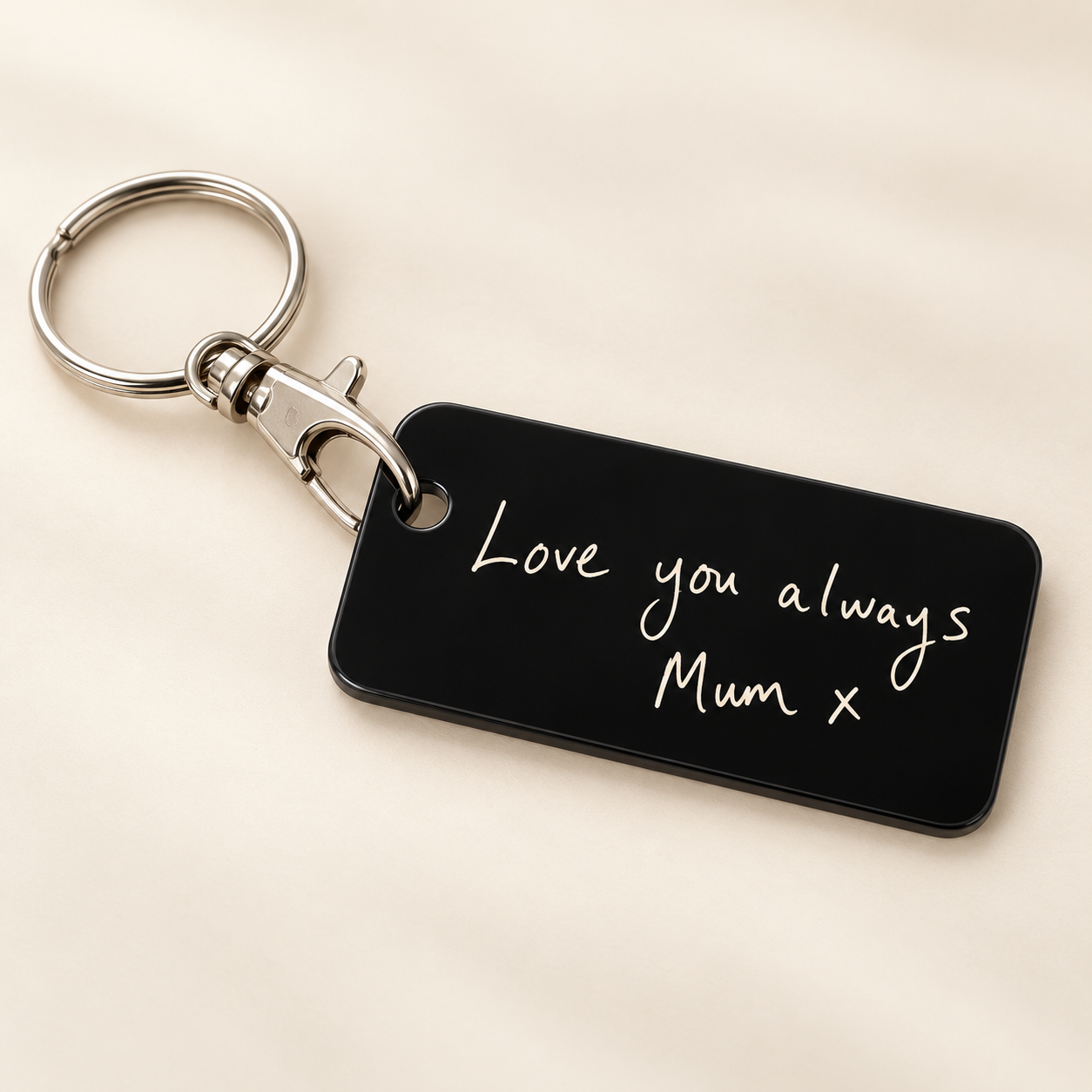 Black acrylic keyring with ivory handwriting reading Love you always and Mum x, attached directly to a silver-tone lobster clasp and round split ring on a cream background.